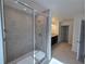 Large bathroom with a walk-in shower and gray tile at 1200 Bear Oak Ln, Deland, FL 32720