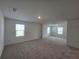 Spacious bedroom with carpet, neutral walls, and multiple windows at 1200 Bear Oak Ln, Deland, FL 32720