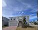 Two-story house with gray siding, two-car garage, and landscaping at 1200 Bear Oak Ln, Deland, FL 32720