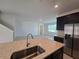 Kitchen island with granite countertop and stainless steel sink at 1200 Bear Oak Ln, Deland, FL 32720