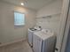 Laundry room with tile floor, shelving, and a washer and dryer at 1200 Bear Oak Ln, Deland, FL 32720