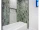 Stylish bathroom with a tub, designer tile surround, and recessed niche at 2239 River Ridge Rd, Deland, FL 32720