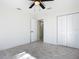Bright bedroom with modern gray tile flooring and ample closet space at 2239 River Ridge Rd, Deland, FL 32720