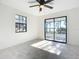 Bedroom with natural light, ceiling fan, and a glass sliding door at 2239 River Ridge Rd, Deland, FL 32720