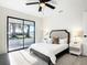 Primary bedroom features large windows with lake views, ceiling fan, and modern design at 2239 River Ridge Rd, Deland, FL 32720