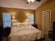 Comfortable bedroom featuring a ceiling fan, ambient sconce lighting, and neutral tones for a serene atmosphere at 328 Sterling Rose Ct, Apopka, FL 32703