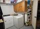 Functional laundry area featuring a washer, dryer, and overhead storage cabinets for convenience and organization at 328 Sterling Rose Ct, Apopka, FL 32703