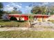 Front view of a ranch-style house with a red door at 4028 Wendy Dr, Orlando, FL 32808