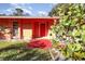 Red front door entryway with landscaping at 4028 Wendy Dr, Orlando, FL 32808