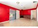 Living room with red walls, tile floors, and a brick fireplace at 4028 Wendy Dr, Orlando, FL 32808