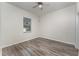 Bedroom with wood-look flooring and a window with blinds at 541 Willet Cir, Auburndale, FL 33823