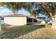 House back view, featuring a screened patio and yard at 541 Willet Cir, Auburndale, FL 33823