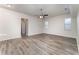 Spacious living room with wood-look floors and ceiling fan at 541 Willet Cir, Auburndale, FL 33823