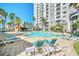 Resort-style pool area with lounge chairs and tropical palm trees for relaxation and enjoyment at 7383 Universal Blvd # 512, Orlando, FL 32819