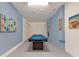 Finished basement with pool table, blue walls with boat decor, and hanging rod, creating a unique entertainment space at 2948 Banana Palm Dr, Kissimmee, FL 34747