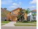 Inviting two-story home featuring a well-maintained lawn, neutral-colored exterior and a two-car garage at 2948 Banana Palm Dr, Kissimmee, FL 34747