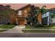 Inviting two-story home featuring a well-maintained lawn, neutral-colored exterior and a two-car garage at 2948 Banana Palm Dr, Kissimmee, FL 34747