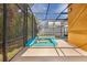 Covered patio with private pool and connected hot tub, next to a grass side yard and view of neighborhood homes at 2948 Banana Palm Dr, Kissimmee, FL 34747