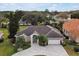 Aerial view of a single-story house with a large backyard and two-car garage at 349 Plantation Club Dr, Debary, FL 32713