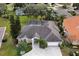Aerial view of a charming single-Gathering home boasting a lush green lawn and a well-manicured landscape at 349 Plantation Club Dr, Debary, FL 32713