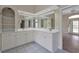 Bathroom with dual sinks, ample counter space, and bright tile flooring at 349 Plantation Club Dr, Debary, FL 32713