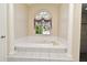 Relaxing bathroom with a large garden tub and tiled surround at 349 Plantation Club Dr, Debary, FL 32713