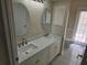 Elegant bathroom with double sinks, quartz countertops, and updated fixtures at 349 Plantation Club Dr, Debary, FL 32713