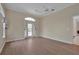 This bright bedroom features light hardwood floors, a ceiling fan, and an arch window at 349 Plantation Club Dr, Debary, FL 32713