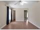 Bedroom with wood floors, ceiling fan, and en-suite bathroom at 349 Plantation Club Dr, Debary, FL 32713