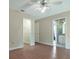 Bedroom featuring wood floors, walk-in closet and bathroom access at 349 Plantation Club Dr, Debary, FL 32713