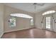 Bright bedroom with wood floors, ceiling fan, and access to backyard at 349 Plantation Club Dr, Debary, FL 32713