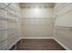 Walk-in closet provides ample storage with shelves and wood flooring at 349 Plantation Club Dr, Debary, FL 32713