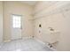 Laundry room with utility sink, overhead shelving, and exterior access at 349 Plantation Club Dr, Debary, FL 32713