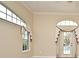 Living room with arched windows and French doors leading to the pool area at 349 Plantation Club Dr, Debary, FL 32713