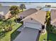 Aerial view of single-story home with lake view and private dock at 446 Sweetwater Way, Haines City, FL 33844