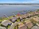 Aerial view of house and community by the lake at 446 Sweetwater Way, Haines City, FL 33844