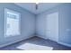 A minimalist bedroom with a large window and neutral carpet at 7760 Sandy Ridge Dr # 222, Kissimmee, FL 34747