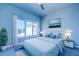 Serene bedroom with a large window, stylish furnishings, and calming blue tones at 7760 Sandy Ridge Dr # 222, Kissimmee, FL 34747