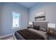 Bedroom with tufted headboard, two side tables, and large window at 7760 Sandy Ridge Dr # 222, Kissimmee, FL 34747