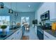 Modern kitchen with an island and stainless steel appliances open to dining area at 7760 Sandy Ridge Dr # 222, Kissimmee, FL 34747