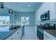 Modern kitchen with stainless steel appliances and an island with a breakfast bar at 7760 Sandy Ridge Dr # 222, Kissimmee, FL 34747