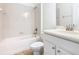 A well-lit bathroom with a tub-shower combo, white fixtures, and a vanity sink at 8914 Dove Valley Way, Davenport, FL 33896