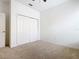 Bedroom featuring neutral carpet, white walls, and a closet with sliding doors at 8914 Dove Valley Way, Davenport, FL 33896
