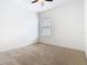 A bright bedroom featuring neutral carpet, white walls, and a window providing natural light at 8914 Dove Valley Way, Davenport, FL 33896