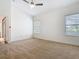 Bright bedroom with neutral carpet, two windows, and a ceiling fan at 8914 Dove Valley Way, Davenport, FL 33896