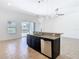 Spacious kitchen island with granite countertops, stainless steel sink, dishwasher, and decorative lighting at 8914 Dove Valley Way, Davenport, FL 33896