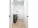 Laundry room featuring tile floors, modern washer and dryer, and ample storage space at 8914 Dove Valley Way, Davenport, FL 33896