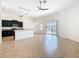 Open floor plan with kitchen, dining, and living areas showcasing tile flooring, modern lighting and sliders to lanai at 8914 Dove Valley Way, Davenport, FL 33896