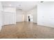 Spacious living room with modern chandelier, neutral walls, and tile flooring throughout the open-concept layout at 8914 Dove Valley Way, Davenport, FL 33896