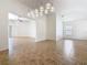 Bright living room featuring modern lighting, neutral walls, and tile flooring, creating a welcoming space at 8914 Dove Valley Way, Davenport, FL 33896